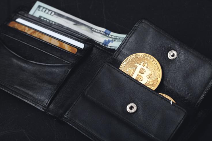A black wallet with a coin slot